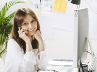 Young businesswoman smiling with a smartphone.