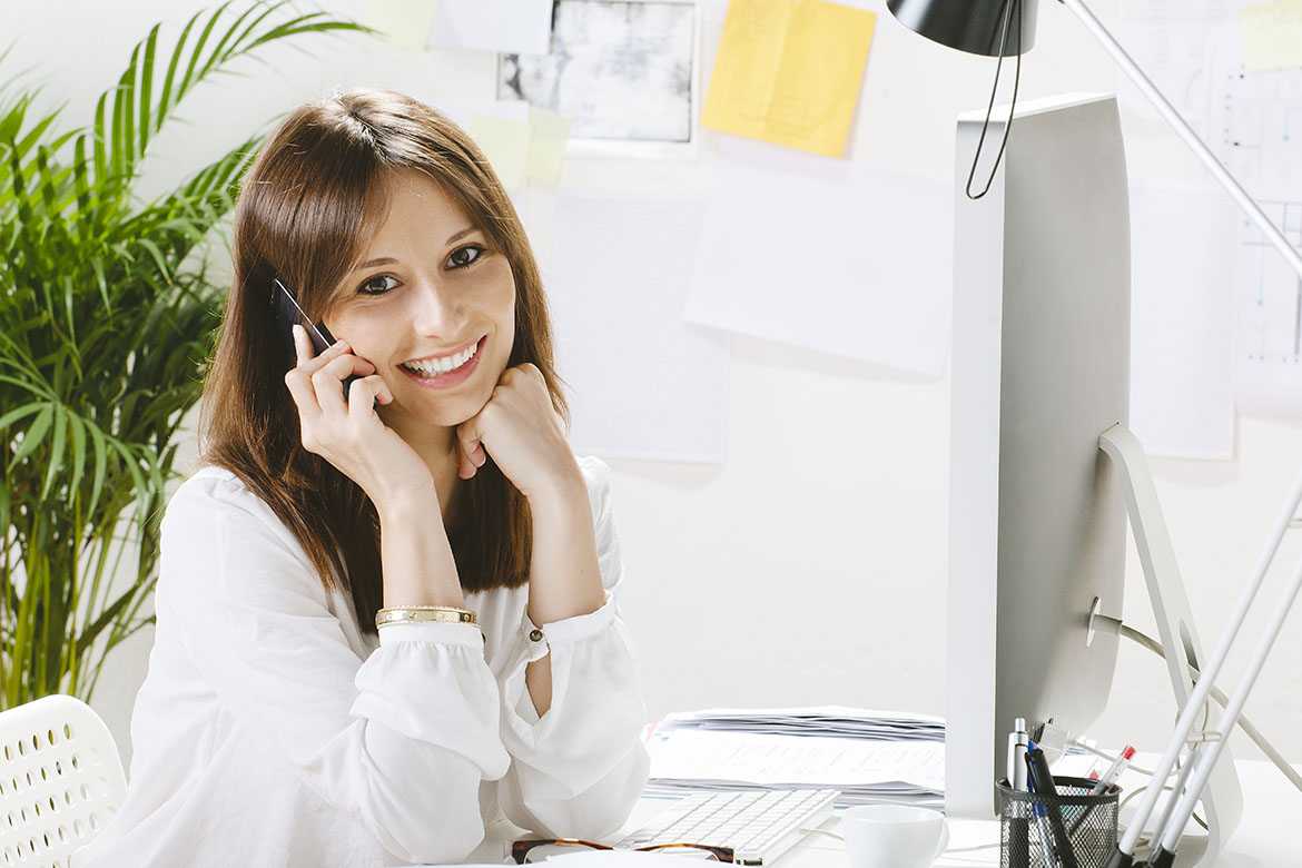 Young businesswoman smiling with a smartphone.